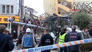 Emergency workers at the site of the collapsed building in Malatya.