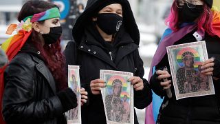 Human rights activists with rainbow Mary and Jesus posters outside court during the defendants' first trial in January