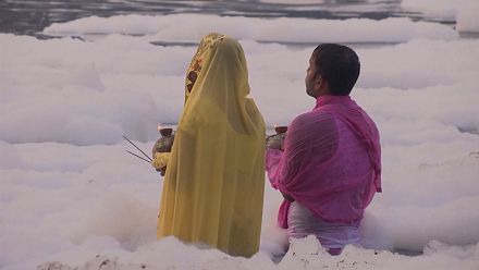 Hindus take holy dip in toxic foam-topped river