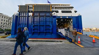 Protesters block the entrance of a ferry in the port of Piraeus, near Athens.