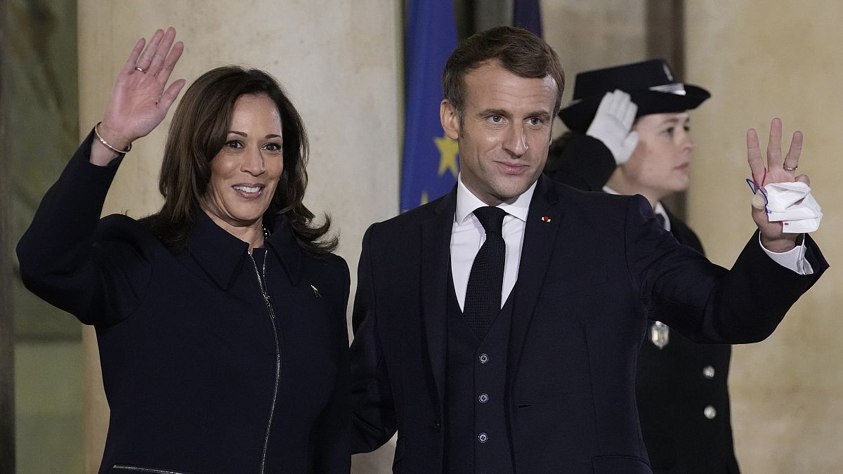 French President Emmanuel Macron and Vice President Kamala Harris wave Wednesday, Nov. 10, 2021 at the Elysee Palace in Paris.