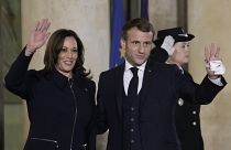 French President Emmanuel Macron and Vice President Kamala Harris wave Wednesday, Nov. 10, 2021 at the Elysee Palace in Paris.