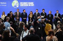 Ministers and representatives of the "Beyond Oil and Gas Alliance" pose on stage at the COP26