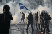 Greek police use tear gas to disperse anti-vaccine protesters during a rally at Syntagma square, central Athens, on Wednesday, July 21, 2021
