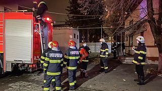 Firefighters operate on the grounds of the hospital in Ploiesti.