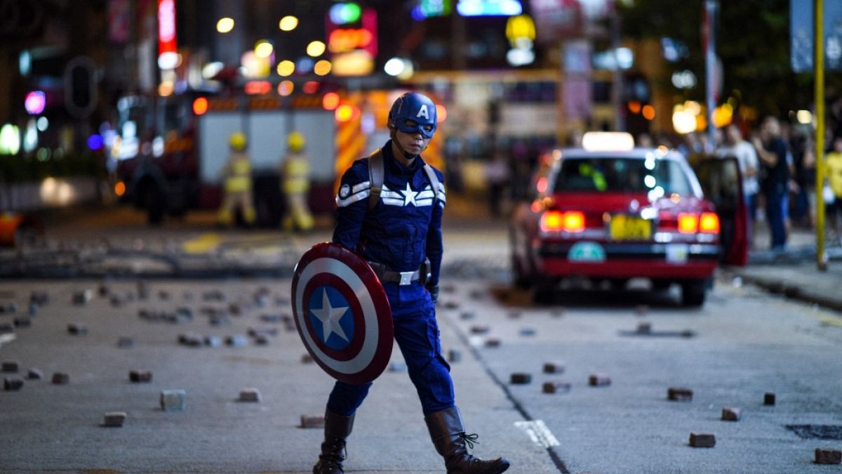 A man wearing a Captain America costume walks near the Mong Kok police station in Hong Kong in October 2019.