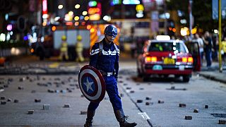 A man wearing a Captain America costume walks near the Mong Kok police station in Hong Kong in October 2019.