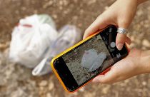 Elishya Ben Meir, an 18-year-old Israeli, uses the "Clean Coin" mobile application to find and safely dispose of abandoned waste, October 20, 2021.