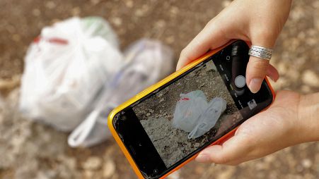 Elishya Ben Meir, an 18-year-old Israeli, uses the "Clean Coin" mobile application to find and safely dispose of abandoned waste, October 20, 2021.