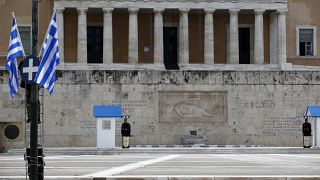Municipal workers install Greek flags in front of the Greek parliament.