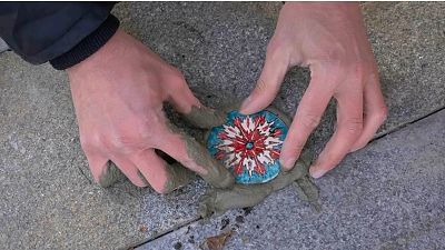 Ivan Kravchenko produces small painted fillings for Russia's many untreated potholes