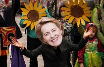A climate activist wearing a mask of European Commission President Ursula von der Leyen takes part in a demo against the use of fossil fuels outside COP26 Glasgow 2021
