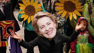 A climate activist wearing a mask of European Commission President Ursula von der Leyen takes part in a demo against the use of fossil fuels outside COP26 Glasgow 2021