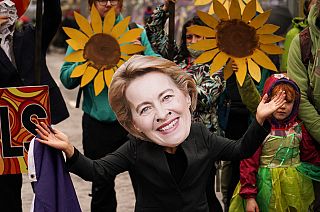 A climate activist wearing a mask of European Commission President Ursula von der Leyen takes part in a demo against the use of fossil fuels outside COP26 Glasgow 2021