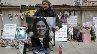 Richard Ratcliffe, husband of Nazanin Zaghari-Ratcliffe, holds up a picture of his wife as he continues his hunger strike outside Britain's Foreign Office on Nov. 11, 2021.