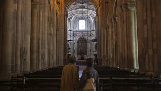 A couple visit the Lisbon Cathedral.