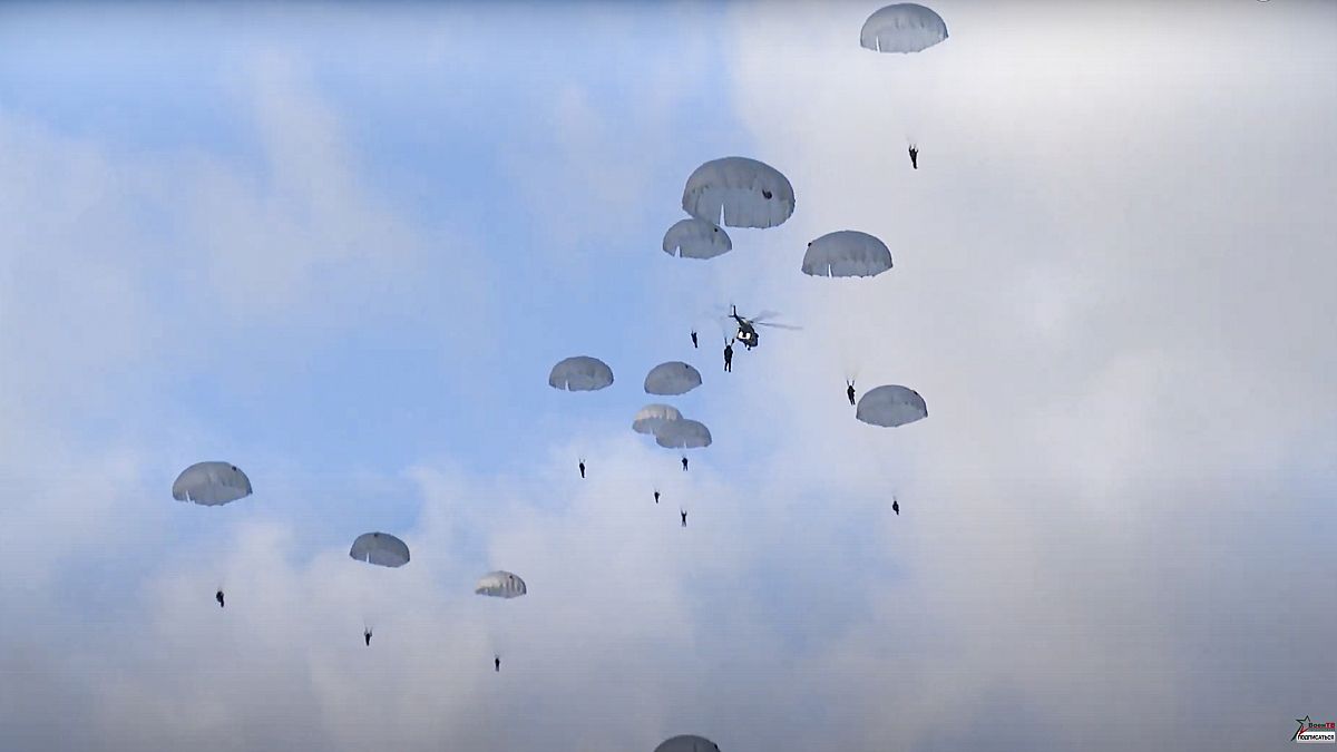 Russian paratroopers jump from military helicopters during joint military exercising near the border with Poland, Belarus,  Nov. 12, 2021.