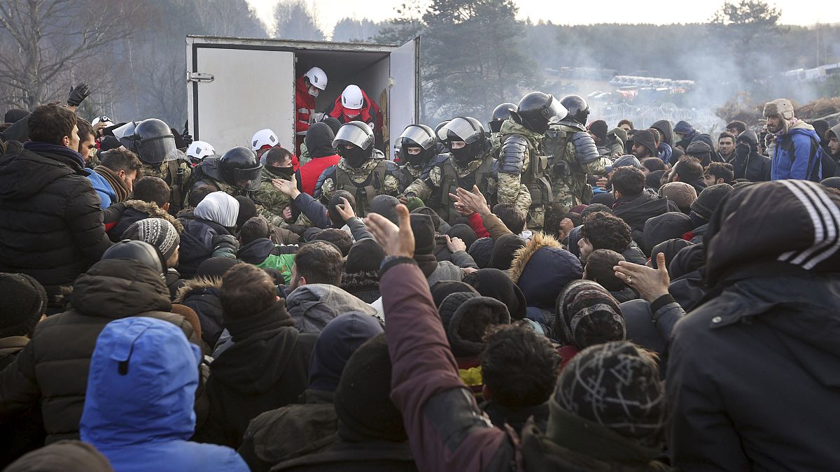 Belarusian servicemen shown while migrants gather at the Belarus-Poland border near Grodno, Belarus, Friday, Nov. 12, 2021.
