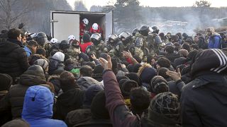 Belarusian servicemen shown while migrants gather at the Belarus-Poland border near Grodno, Belarus, Friday, Nov. 12, 2021.