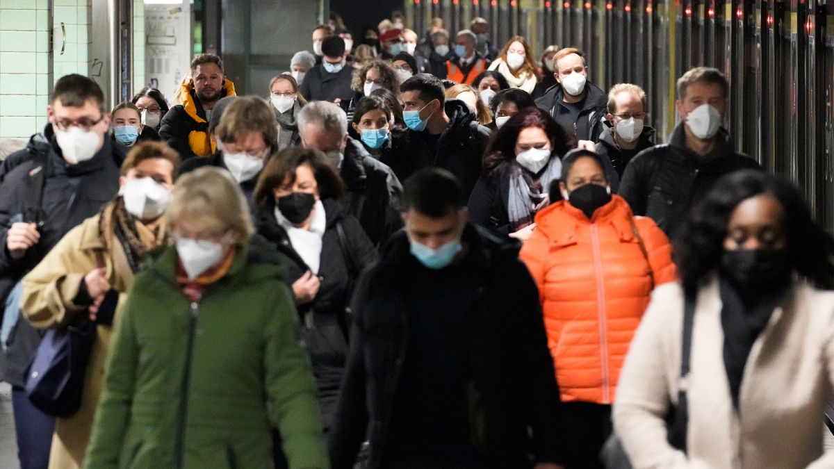 Commuters wearing face masks to protect against the coronavirus as they arrives at the public transport station Brandenburger Tor in central Berlin, Germany.