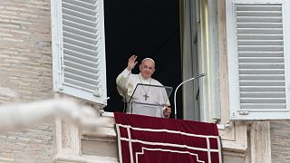 Pope Francis waves to faithful on the occasion of the Angelus noon prayer in St. Peter's Square, at the Vatican, Sunday, Nov. 14, 2021.