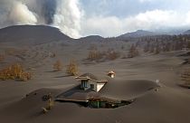 A house is covered by ash from a volcano as it continues to erupt on the Canary island of La Palma