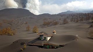 A house is covered by ash from a volcano as it continues to erupt on the Canary island of La Palma