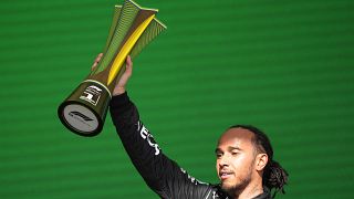 Mercedes driver Lewis Hamilton, of Britain, celebrates at the podium after winning the Brazilian Formula One Grand Prix