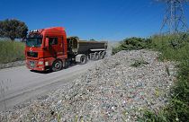A truck unloads by an illegal garbage dump on the outskirts of Istanbul, May 2021.