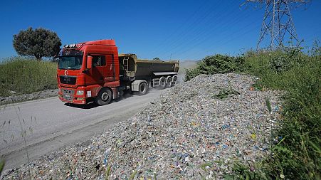 A truck unloads by an illegal garbage dump on the outskirts of Istanbul, May 2021.