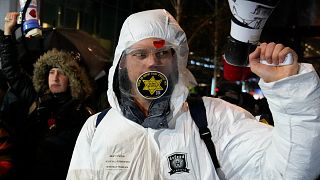 Protestors during a demonstration against COVID-19 restrictions outside a ministry building in The Hague, Netherlands, Nov. 26, 2021. Protestors during a demonstration against COVID-19 restrictions outside a ministry building in The Hague, Netherlands, Nov. 26, 2021.