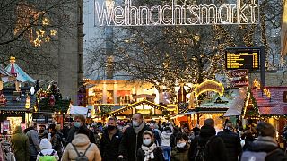 People walk at the Christmas market in Dortmund, Germany, Wednesday, Dec. 1, 2021. People walk at the Christmas market in Dortmund, Germany, Wednesday, Dec. 1, 2021.