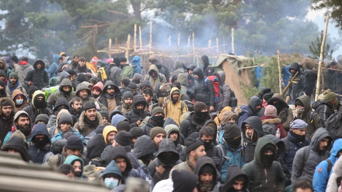 Migrants head towards the Polish Kuznica border crossing on the Belarusian-Polish border on November 15, 2021.