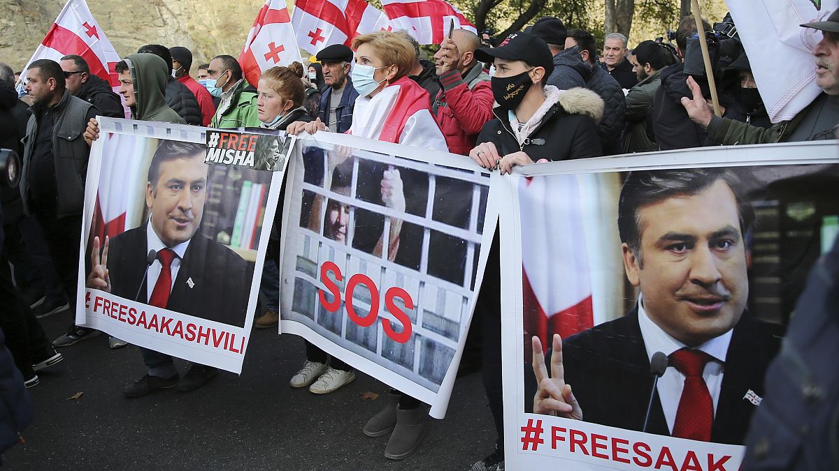 Georgian opposition demonstrators with images of former President Mikheil Saakashvili rally in his support in Tbilisi, Georgia, Monday, Nov. 15, 2021. 