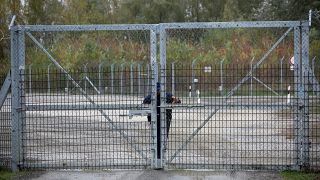 Un policía cierra la puerta de un centro para migrantes en Roszke, Hungría