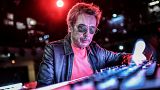 French composer and producer Jean-Michel Jarre poses on stage prior to perform a 2021 New Year's Eve virtual reality concert "Welcome to the other side"