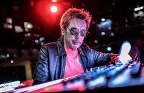 French composer and producer Jean-Michel Jarre poses on stage prior to perform a 2021 New Year's Eve virtual reality concert "Welcome to the other side"
