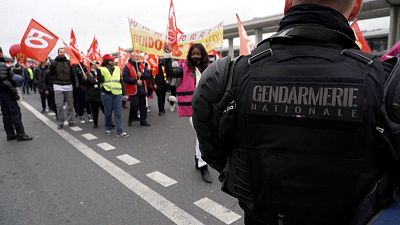 Protesters blocking road between terminals at Roissy Charles-De-Gaules airport.