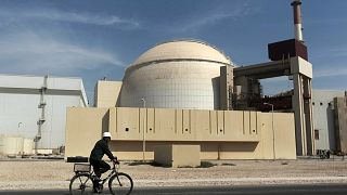 FILE - A worker rides a bicycle in front of the reactor building of the Bushehr nuclear power plant, just outside the southern city of Bushehr, Iran, Oct. 26, 2010.
