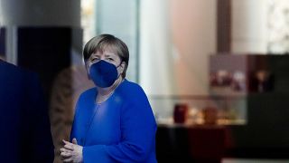 FILE - German Chancellor Angela Merkel waits for the arrival of Denmark's Queen Margrethe II for meeting at the chancellery in Berlin, Germany.
