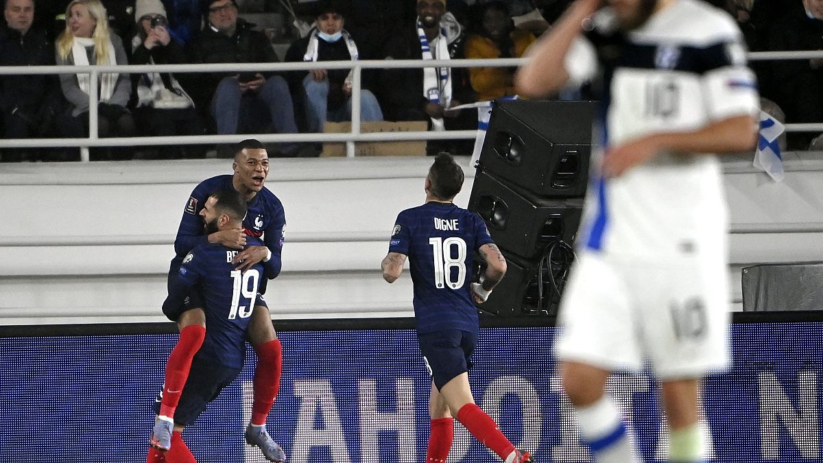 France's Karim Benzema celebrates with teamates Kylian Mbappe and Lucas Digne, after scoring their side's first goal during the match between Finland and France.