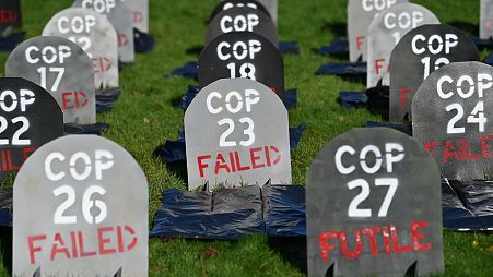 Mock headstones are pictured at Glasgow Necropolis to symbolise the failure of the COP26 process, at Glasgow Cathedral in Glasgow on November 13, 2021.