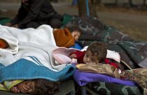 FILE: Yazidi refugee children from Mosul, Iraq, sleep with their family near an abandoned military barrack in Beli Manastir, northeast Croatia, Saturday, Sept. 19,2015. 