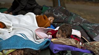 FILE: Yazidi refugee children from Mosul, Iraq, sleep with their family near an abandoned military barrack in Beli Manastir, northeast Croatia, Saturday, Sept. 19,2015. 