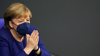German Chancellor Angela Merkel reacts during a parliament Bundestag session about new measures to battle the coronavirus pandemic, Germany, Nov. 18, 2021.