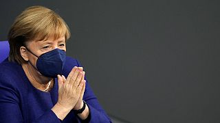 German Chancellor Angela Merkel reacts during a parliament Bundestag session about new measures to battle the coronavirus pandemic, Germany, Nov. 18, 2021. 