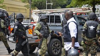 Security forces secure the scene of a blast on a street near the parliamentary building in Kampala, Uganda, Tuesday, Nov. 16, 2021. 