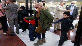 امرأة عراقية تصل مع طفليها إلى مطار بغداد بعد عودتهم من العاصمة البيلاروسية مينسك في 18 نوفمبر 2021
