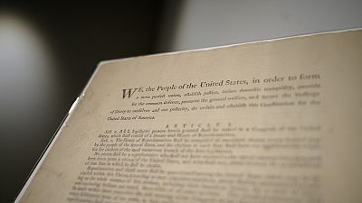 In this file photo taken on September 17, 2021 a page of the first printing of the US Constitution is displayed at the offices of Sotheby's auction house in New York.