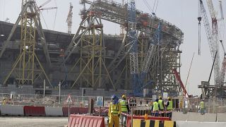 File photo: Workers walk to the Lusail Stadium, one of the 2022 World Cup stadiums, in Lusail, Qatar